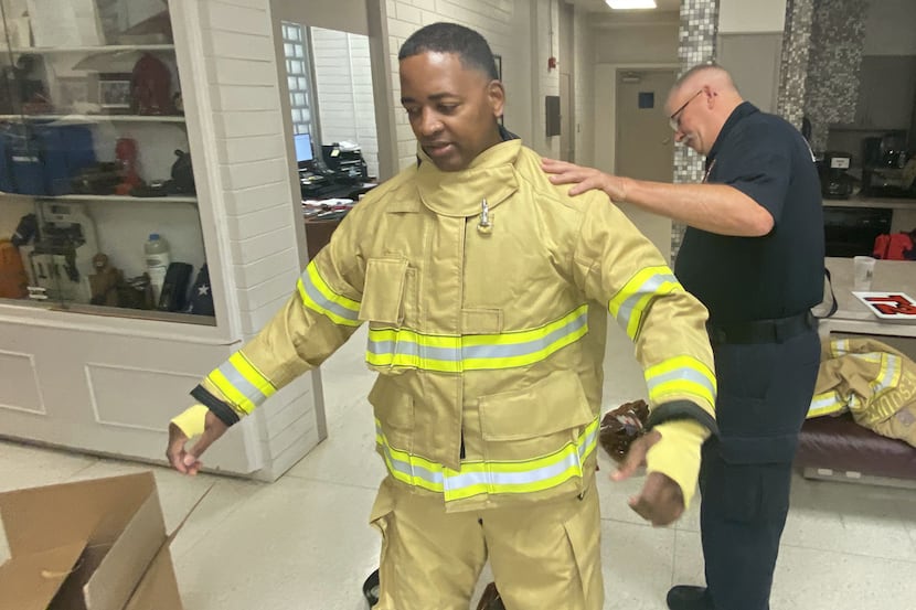 A Mesquite firefighter is fitted with new bunker gear. The city's fire department now has...