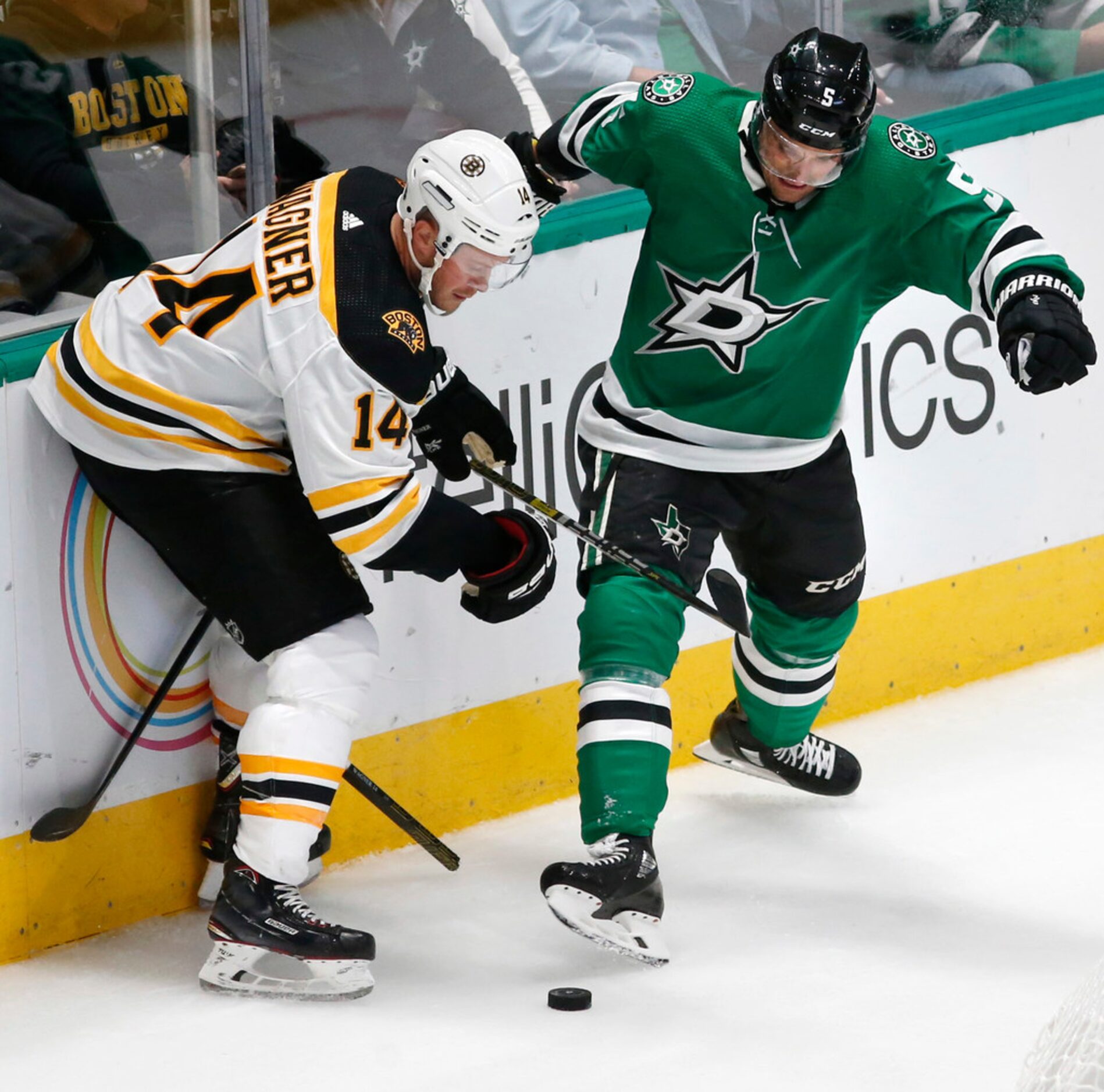 Dallas Stars defenseman Andrej Sekera (5) kicks the puck as Boston Bruins right wing Chris...