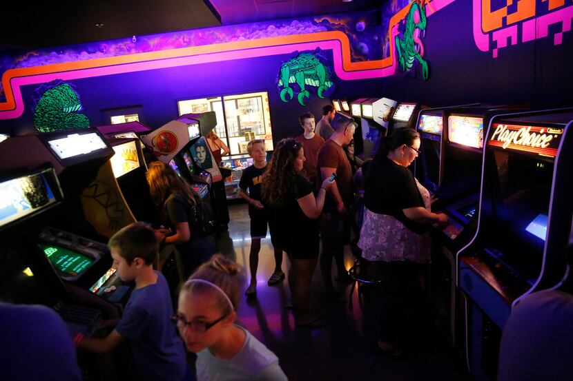 People play video games at the National Videogame Museum in Frisco on Aug. 2, 2018. (Rose...