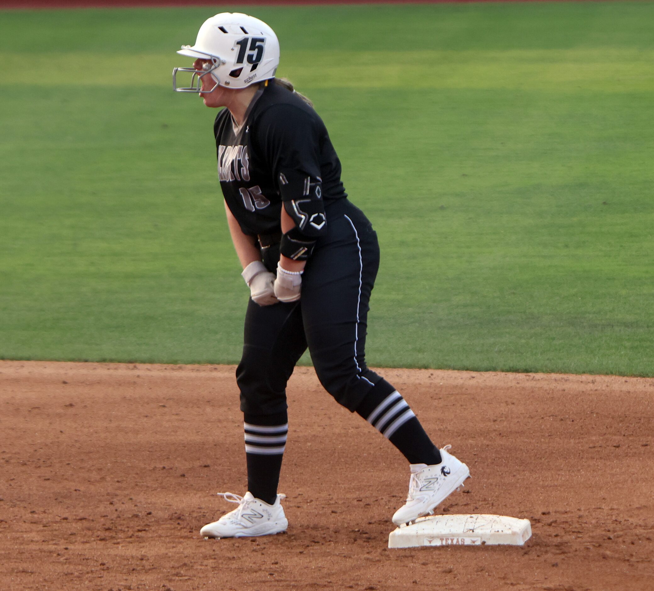 Denton Guyer's Erin Love (15) lets out a yell directed to teammates in the dugout after...