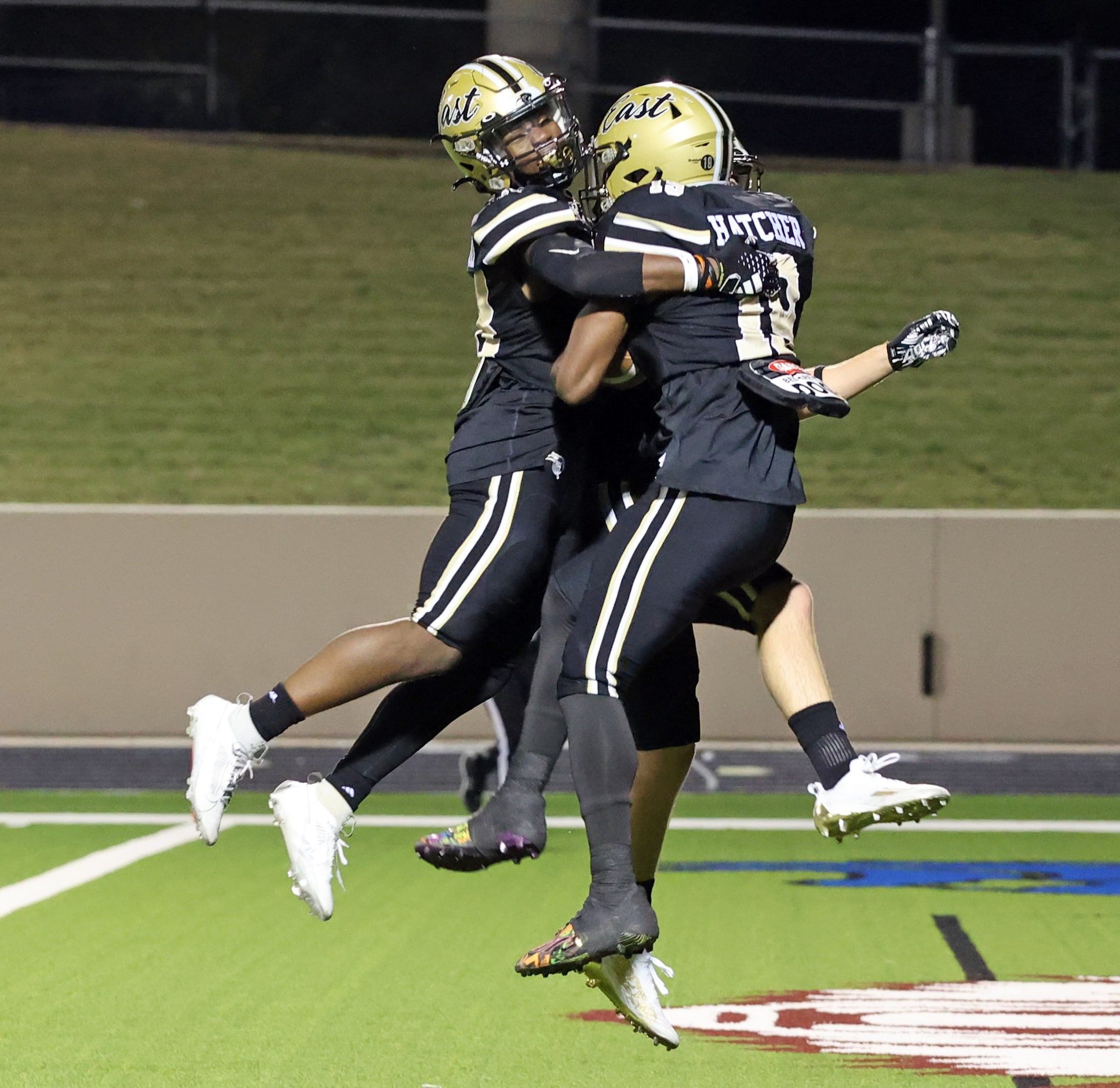 Plano East high WR Jaylon Hatcher (19) celebrates with two teammates, including Caden Warner...