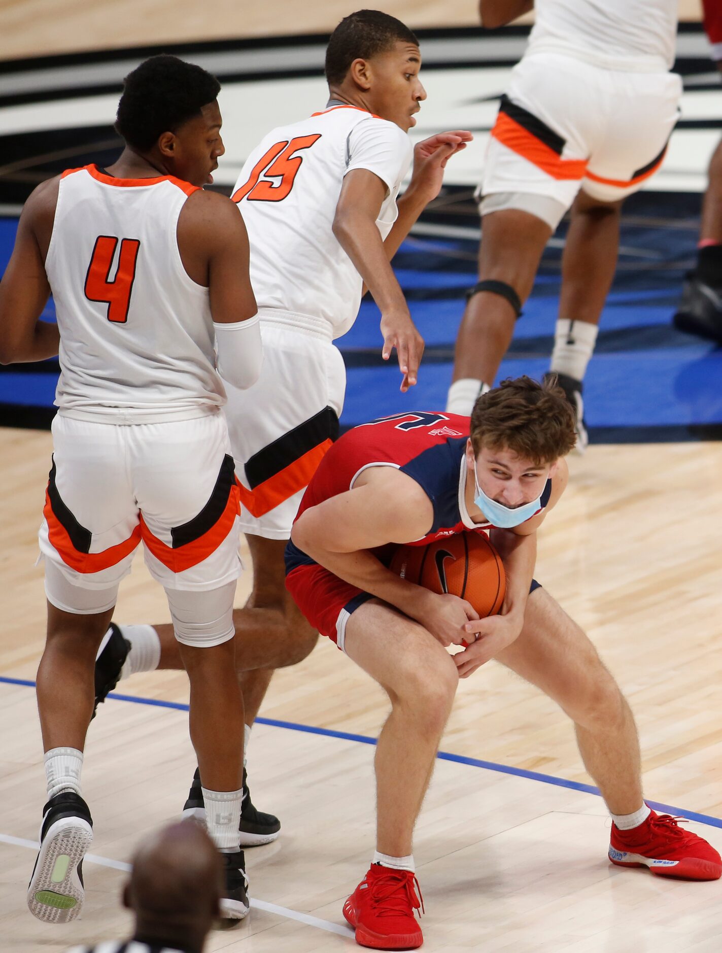 Plano John Paul ll senior Nick Kendall (5) appears to be hiding the ball to protect...