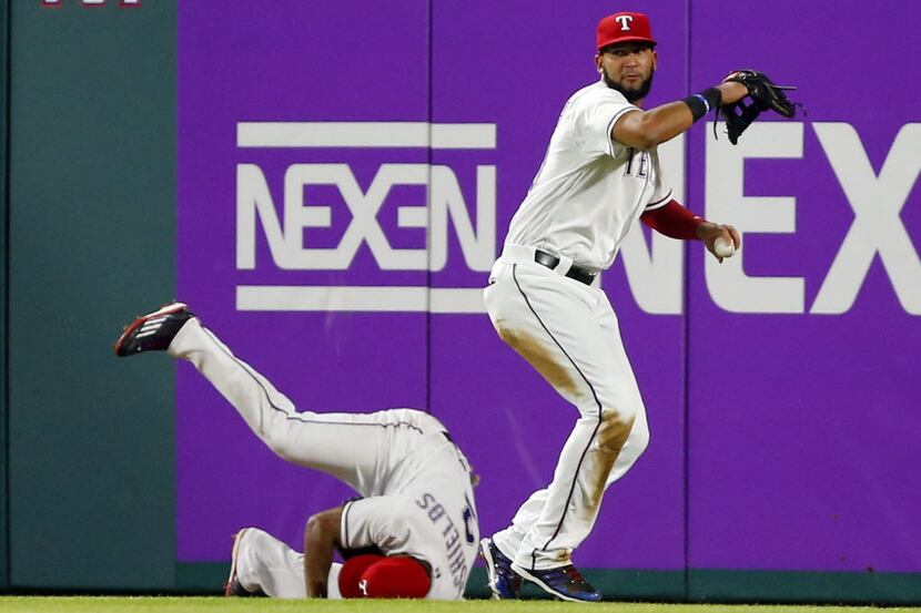 Texas Rangers right fielder Nomar Mazara (30) collects the ball off the wall and throws it...