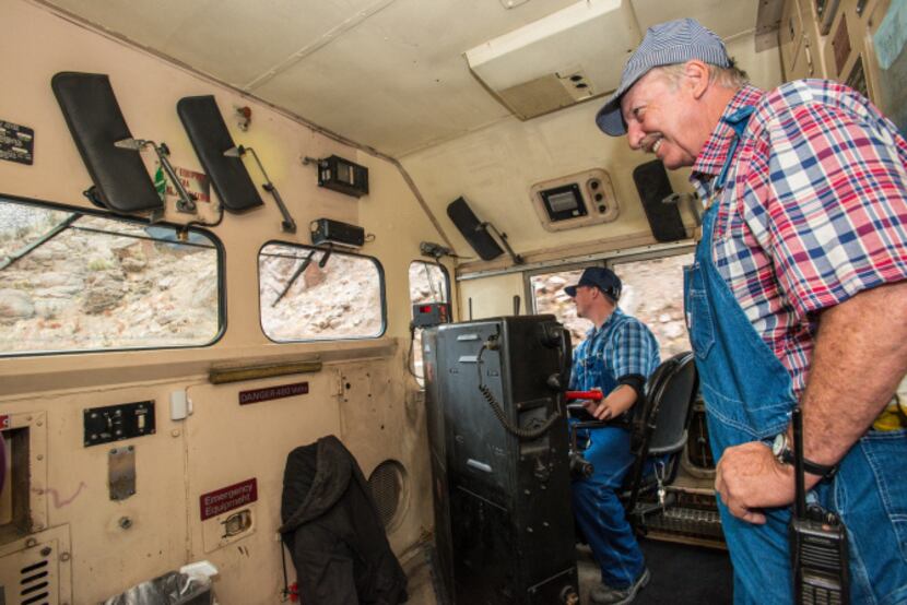 Veteran engineer, Wayne Gay, supervises as trainee Devon Cacy mans the locomotive's controls.
