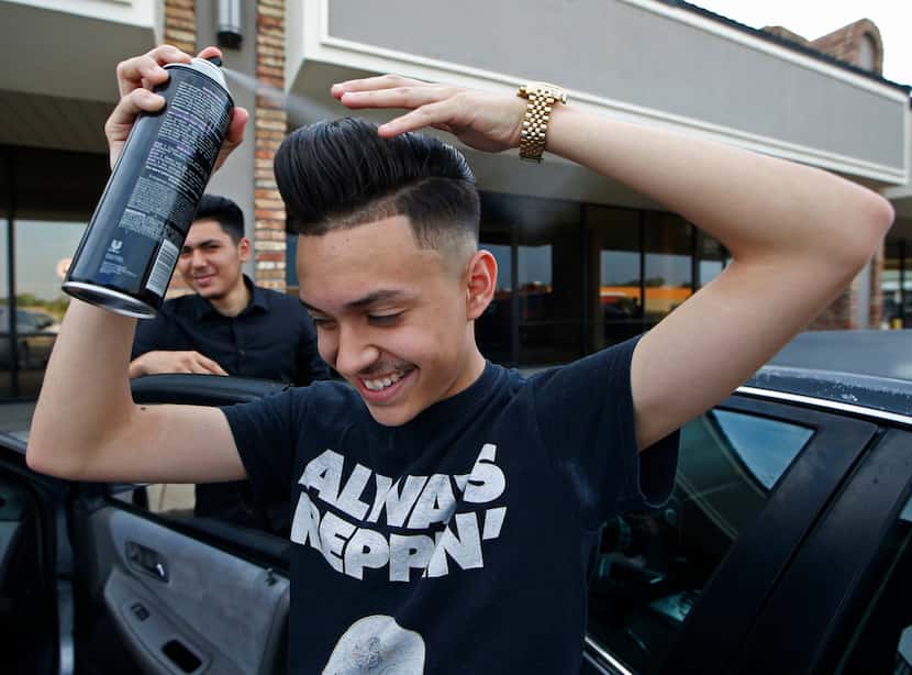 Gustavo Antunez perfects his pompadour hairstyle with hairspray before dancing at a...