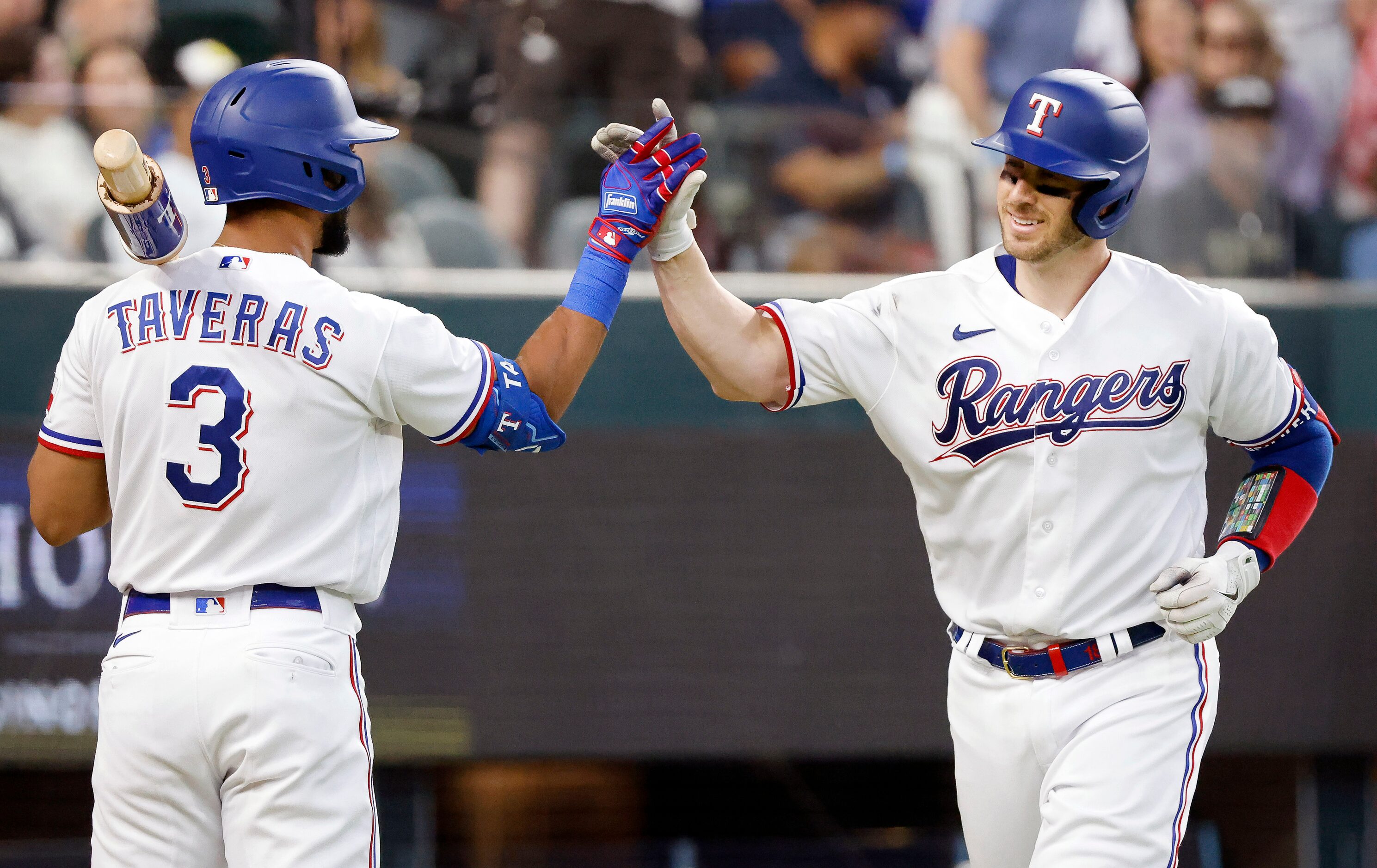 Texas Rangers catcher Mitch Garver (right) is congratulated on his fourth inning homer by...