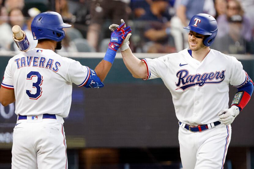 Texas Rangers catcher Mitch Garver (right) is congratulated on his fourth inning homer by...