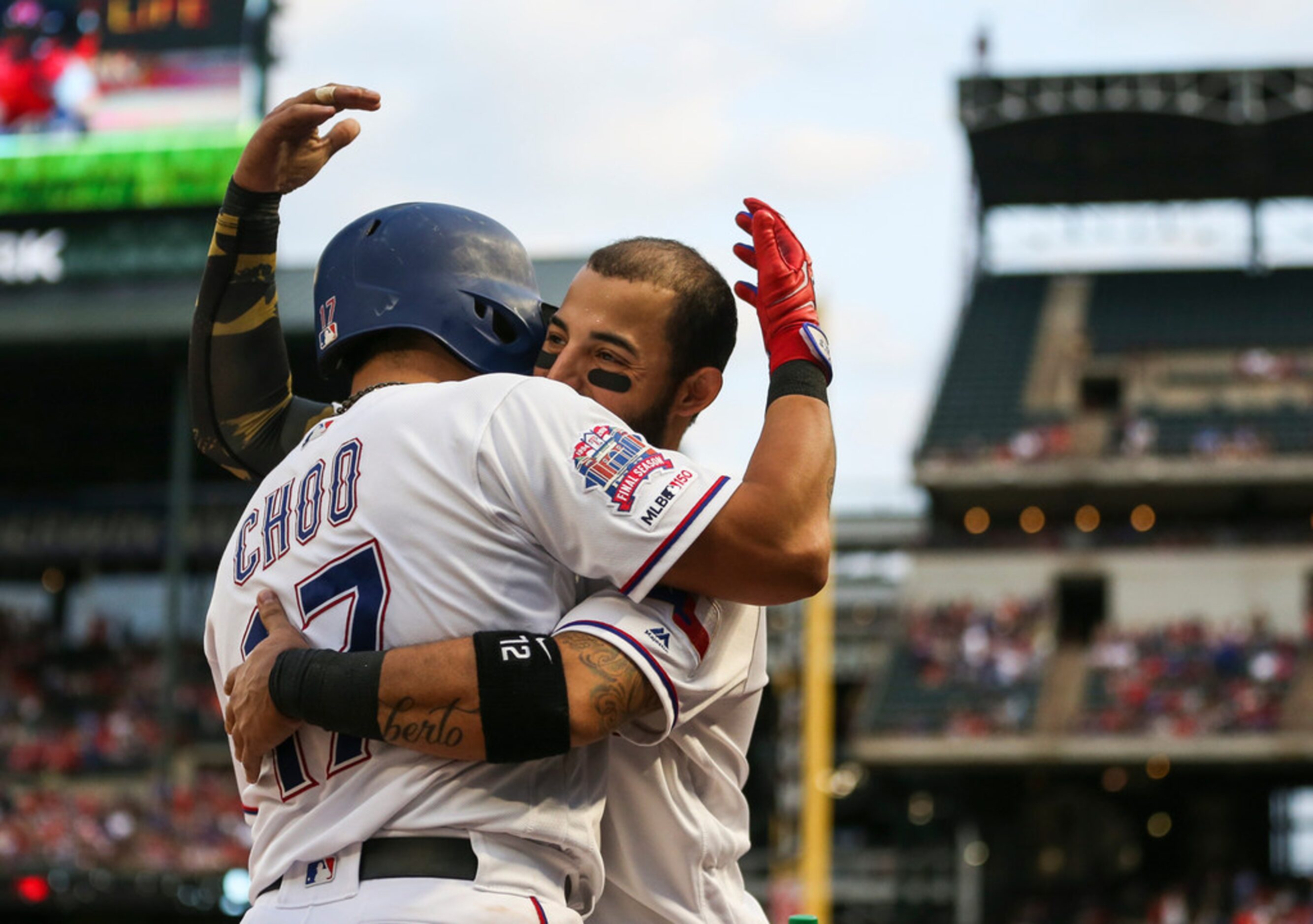 Texas Rangers right fielder Shin-Soo Choo (17) embraces Texas Rangers second baseman Rougned...