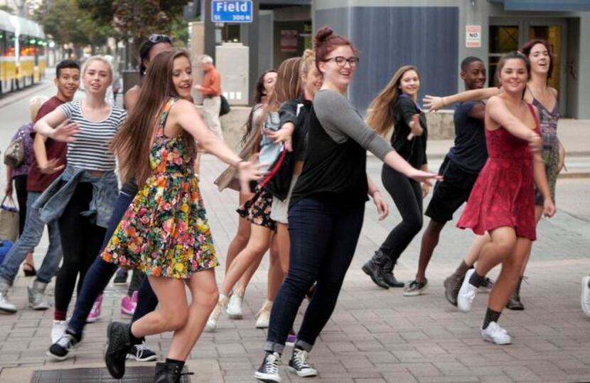 
A “flash mob” of Booker T. Washington students dances at DART’s Akard Station downtown to...