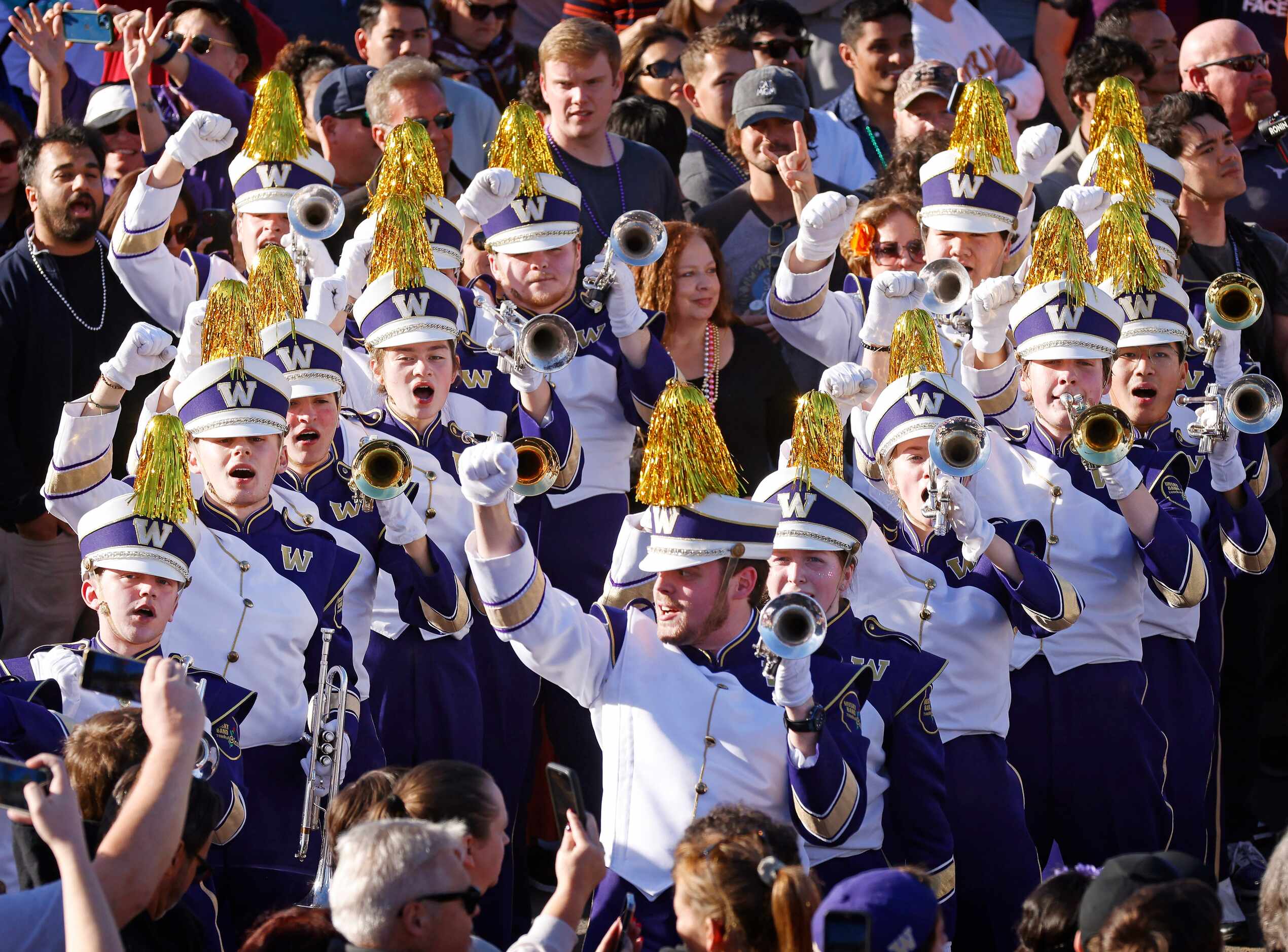 The University of Washington Husky Marching Band cheers as they perform in the Mardi...