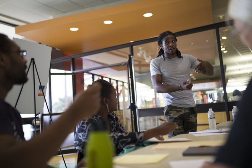 Tro'juan Henderson (right), a spoken word artist and poet, leads an workshop during Make Art...