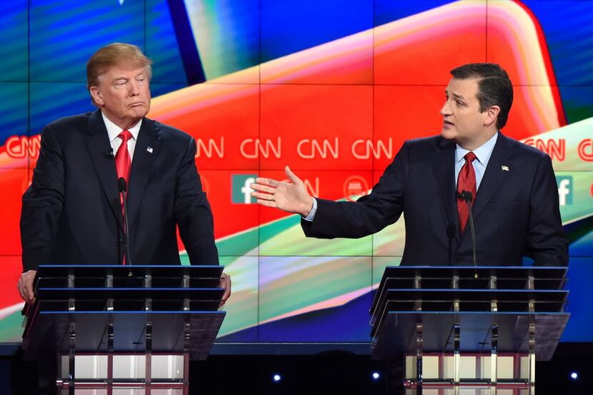 Sen. Ted Cruz speaks as Donald Trump looks on during a Republican presidential debate in Las...