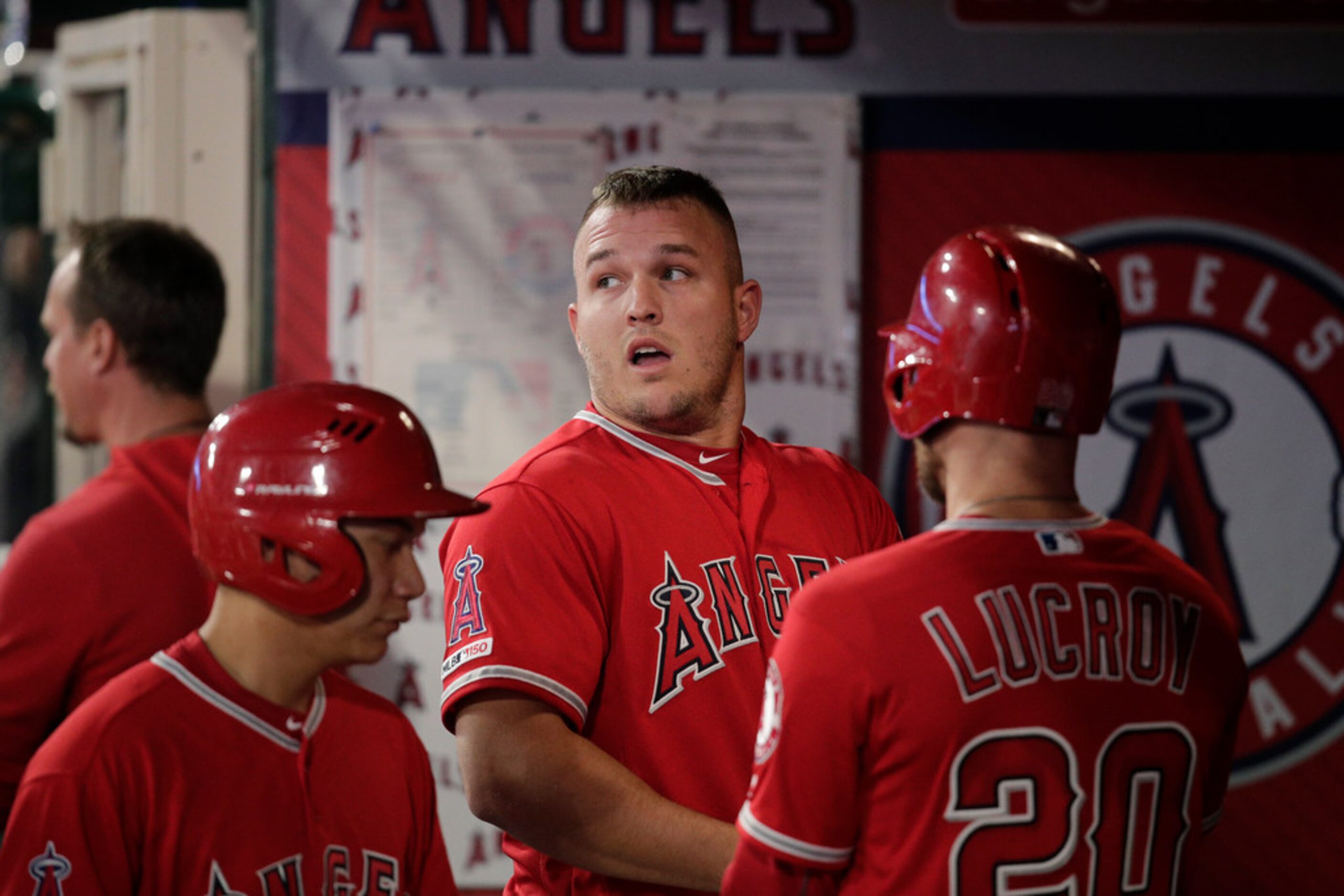 Los Angeles Angels' Mike Trout watches from the dugout after he flied out during the first...