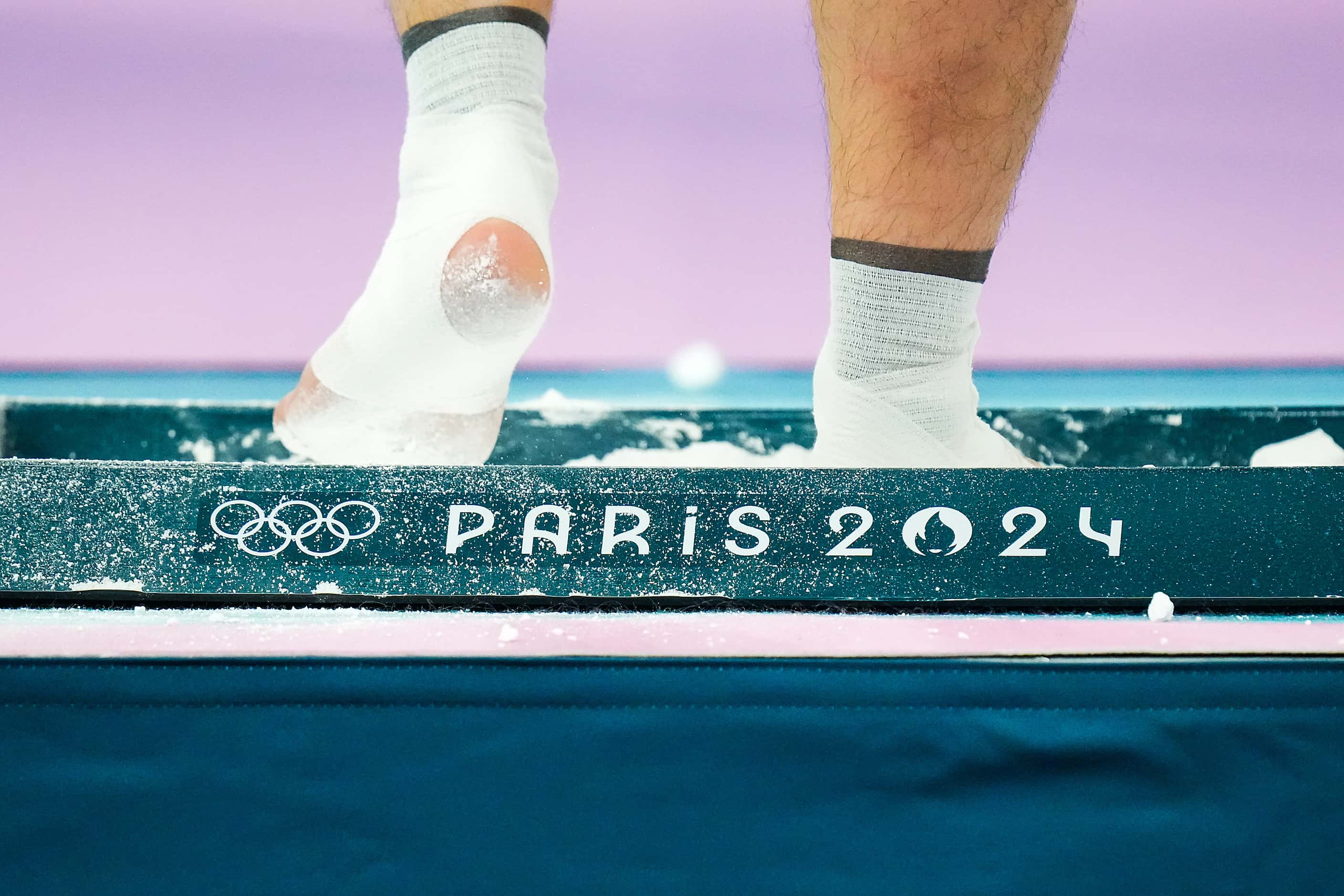 Asher Hong of the United States steps in a chalk box during gymnastics podium training ahead...