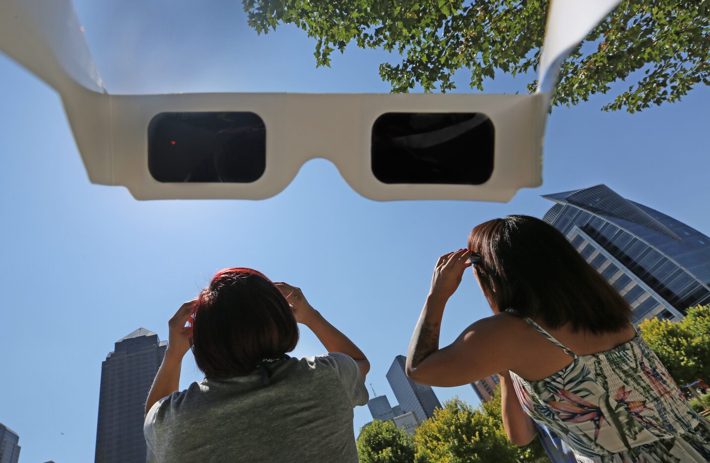 Rose Chavez and Adri Robles watched the solar eclipse through special sunglasses at Klyde...