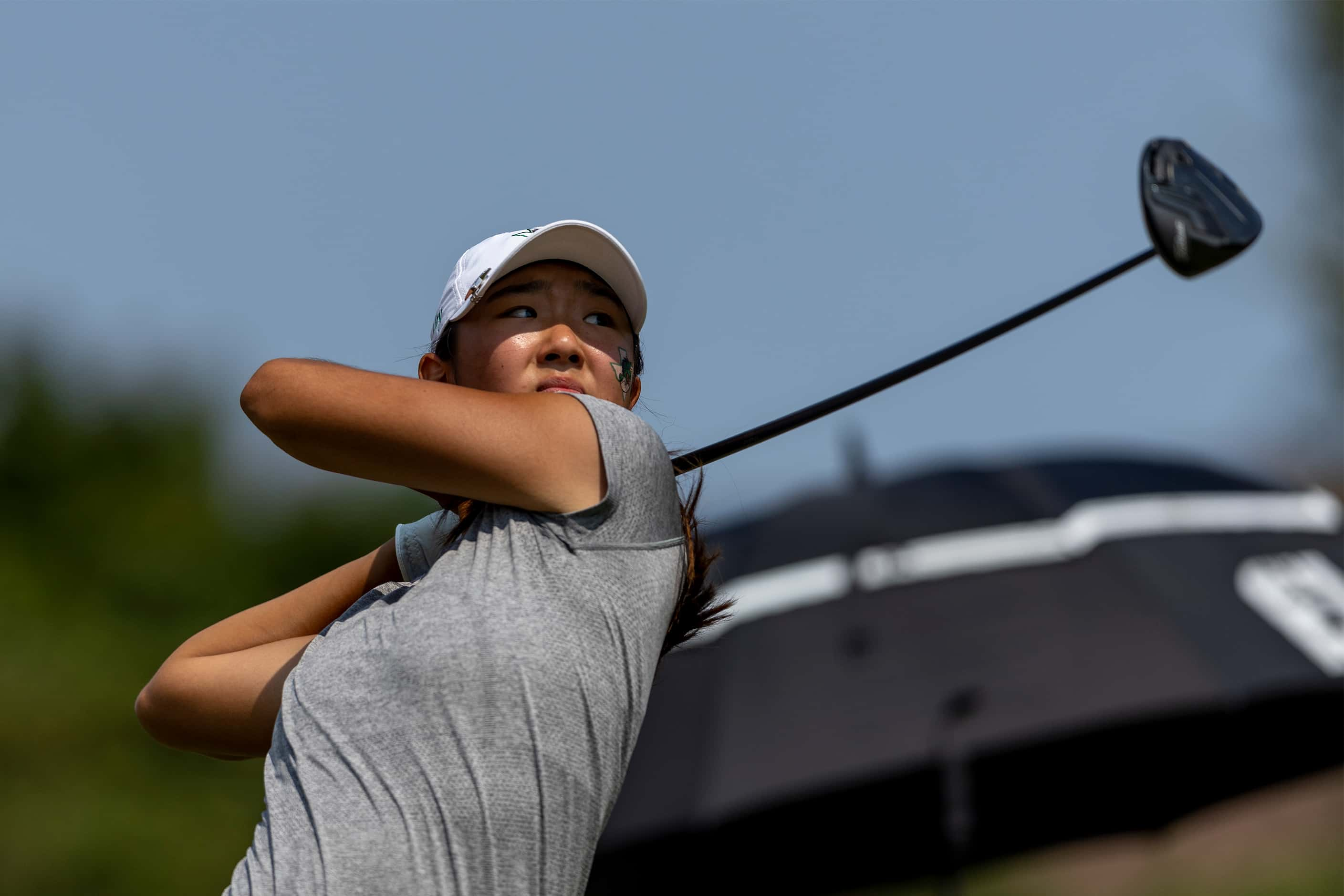 Southlake Carroll’s Ashley Kim hits from the 10th tee box during the 6A girls state golf...