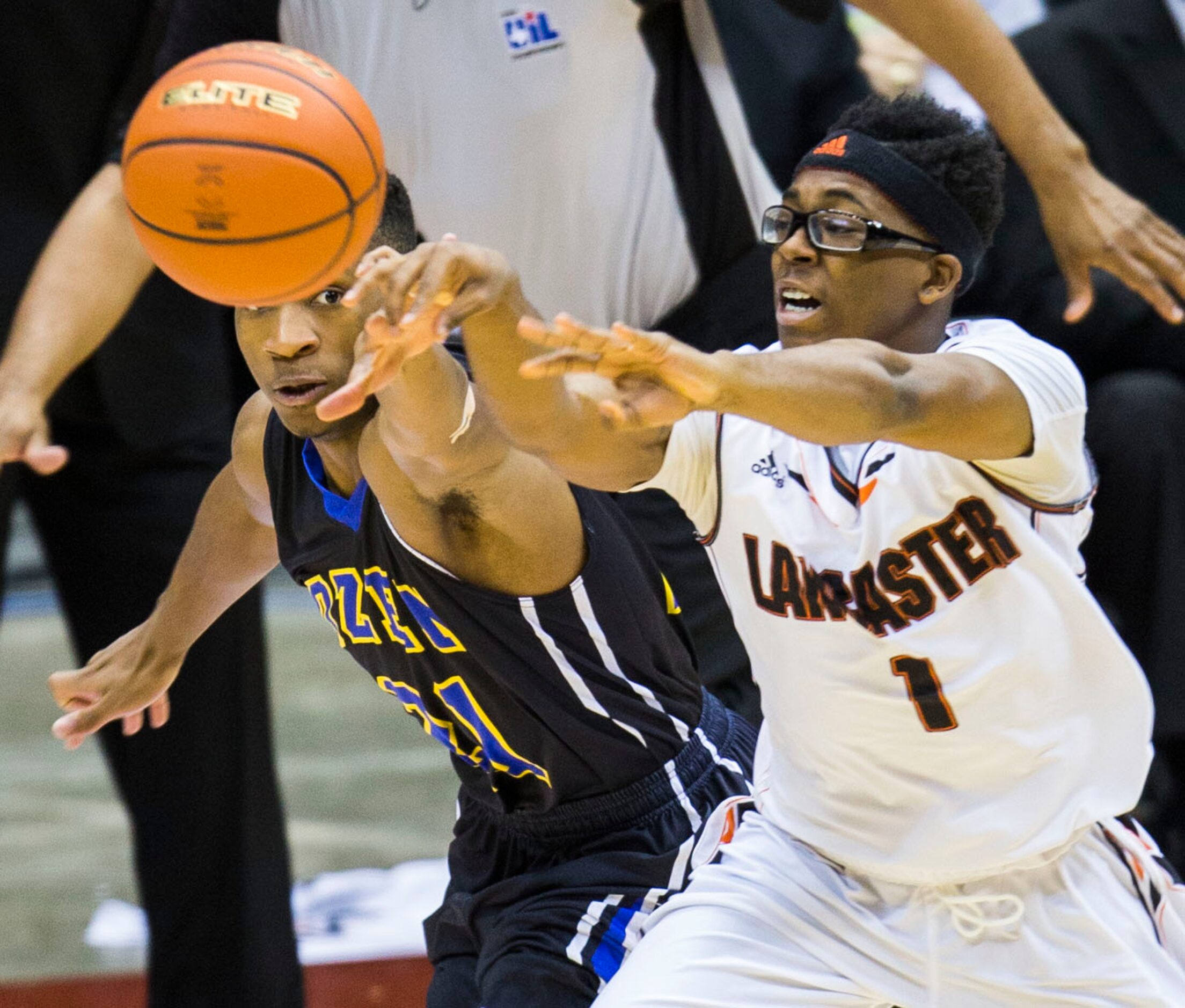 Lancaster guard Dominique Fobbs (1) passes while Beaumont Ozen guard John Comeaux (21)...