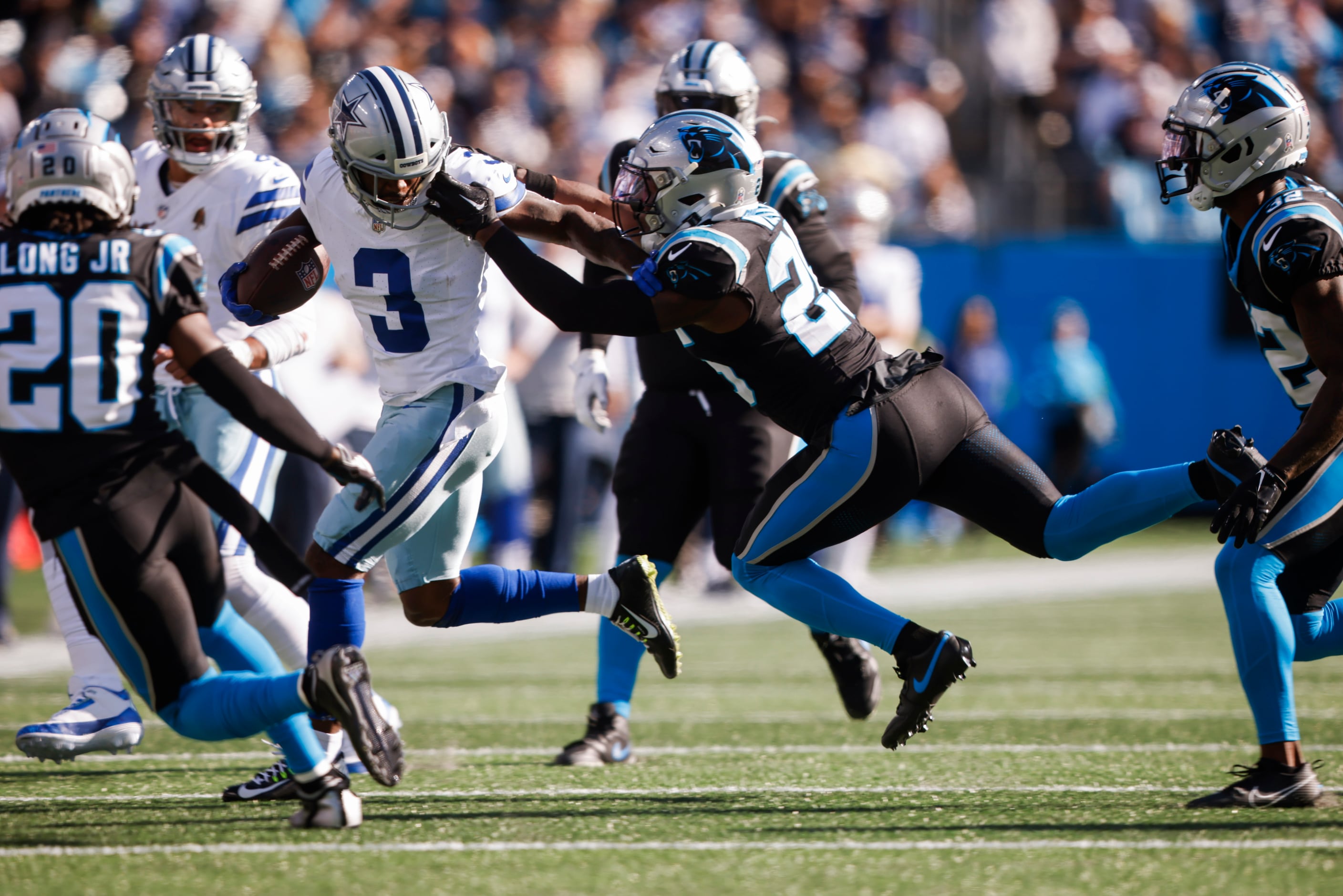 Carolina Panthers safety Xavier Woods (25) grabs Dallas Cowboys wide receiver Brandin Cooks’...