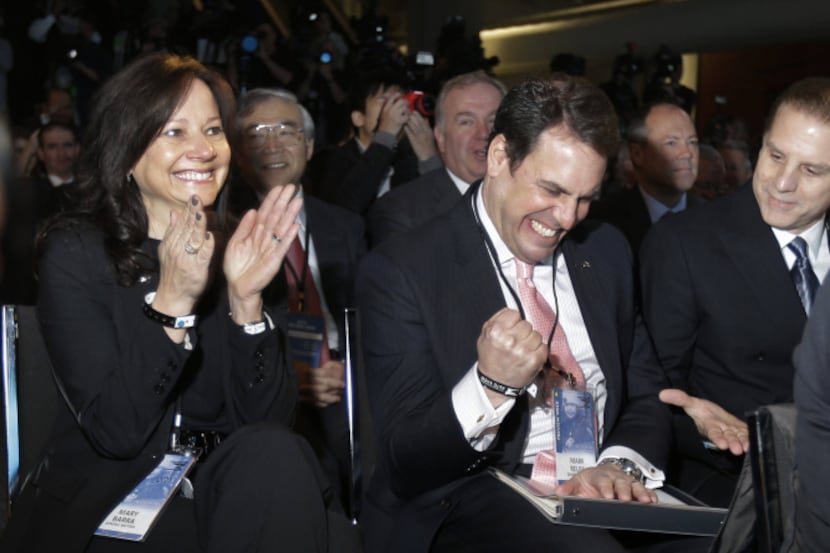 Mary Barra, left, Mark Reuss and David Leone react after the Cadillac ATS was named North...