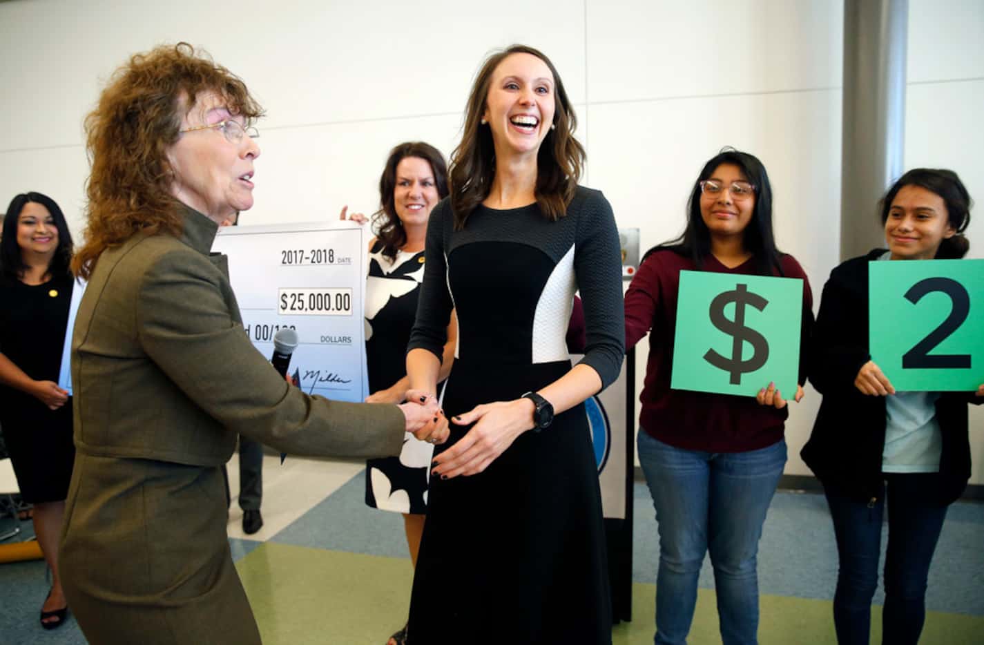 Arlington Collegiate High School teacher Jennifer Fuller (center) is congratulated by Milken...