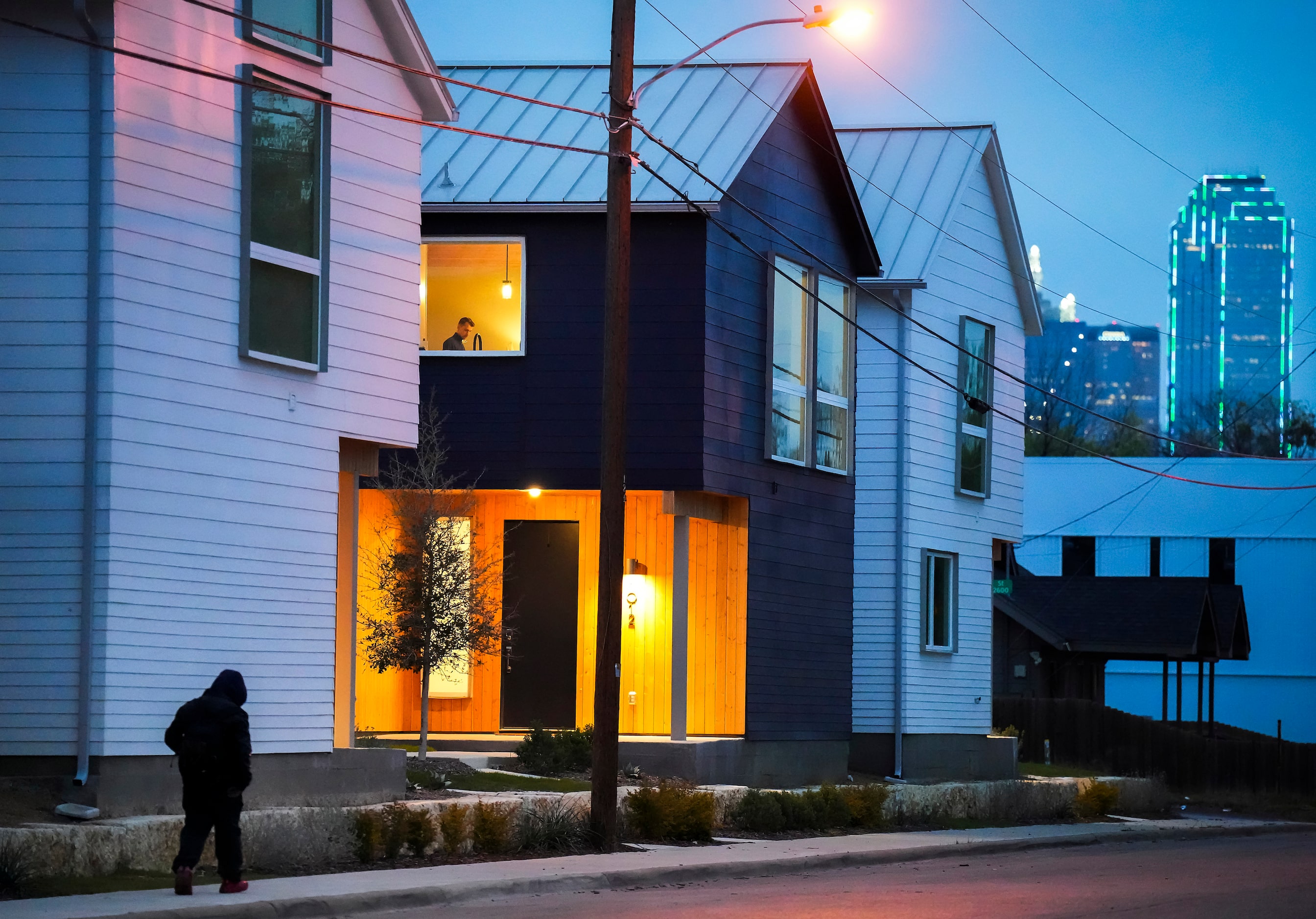 The downtown skyline is seen in the distance behind newly constructed homes in the...