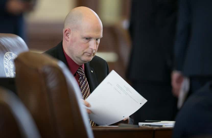 In this March 28 file photo, State Rep. Tony Tinderholt, R-Arlington, works at his desk  in...