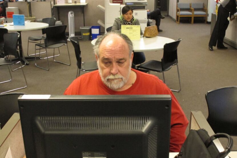 Richard Mattos, 59, looks through job listings at a state-run employment center in Oregon....