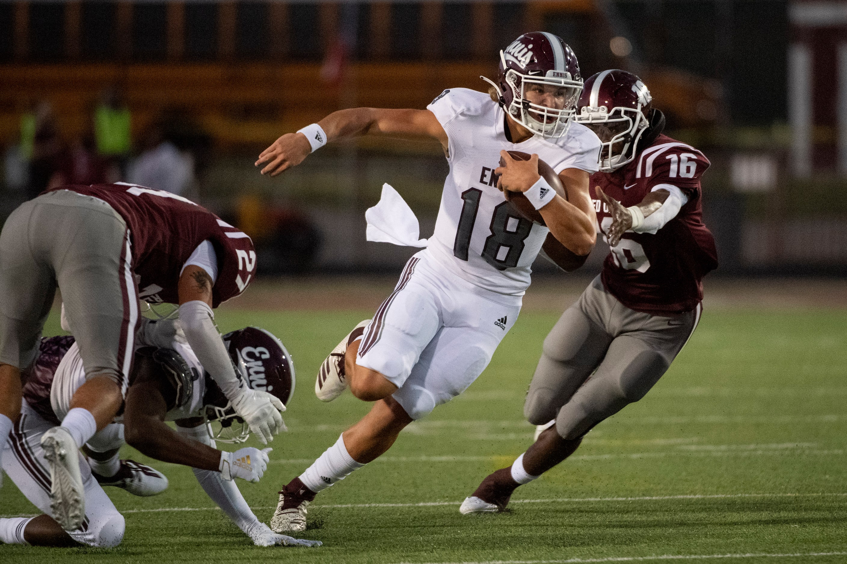 Ennis senior quarterback Collin Drake (18) turns upfield past Red Oak senior Devin Steen...