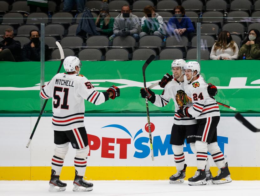 Chicago Blackhawks center Pius Suter (24) celebrates his game winning goal scored with...