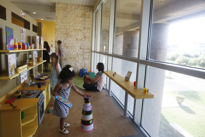 Kids play in the kitchen area at the Ready to Read Railroad at the Frisco Public Library....