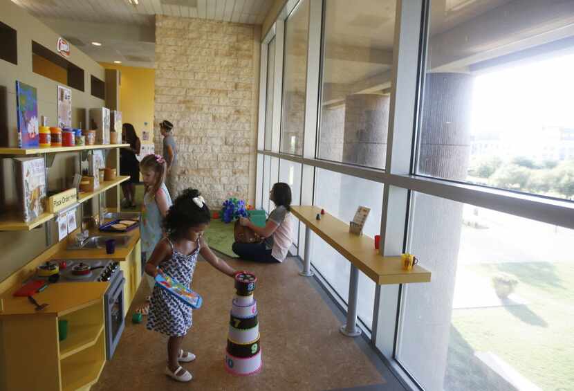 Kids played in the kitchen area at the Ready to Read Railroad at the Frisco Public Library.