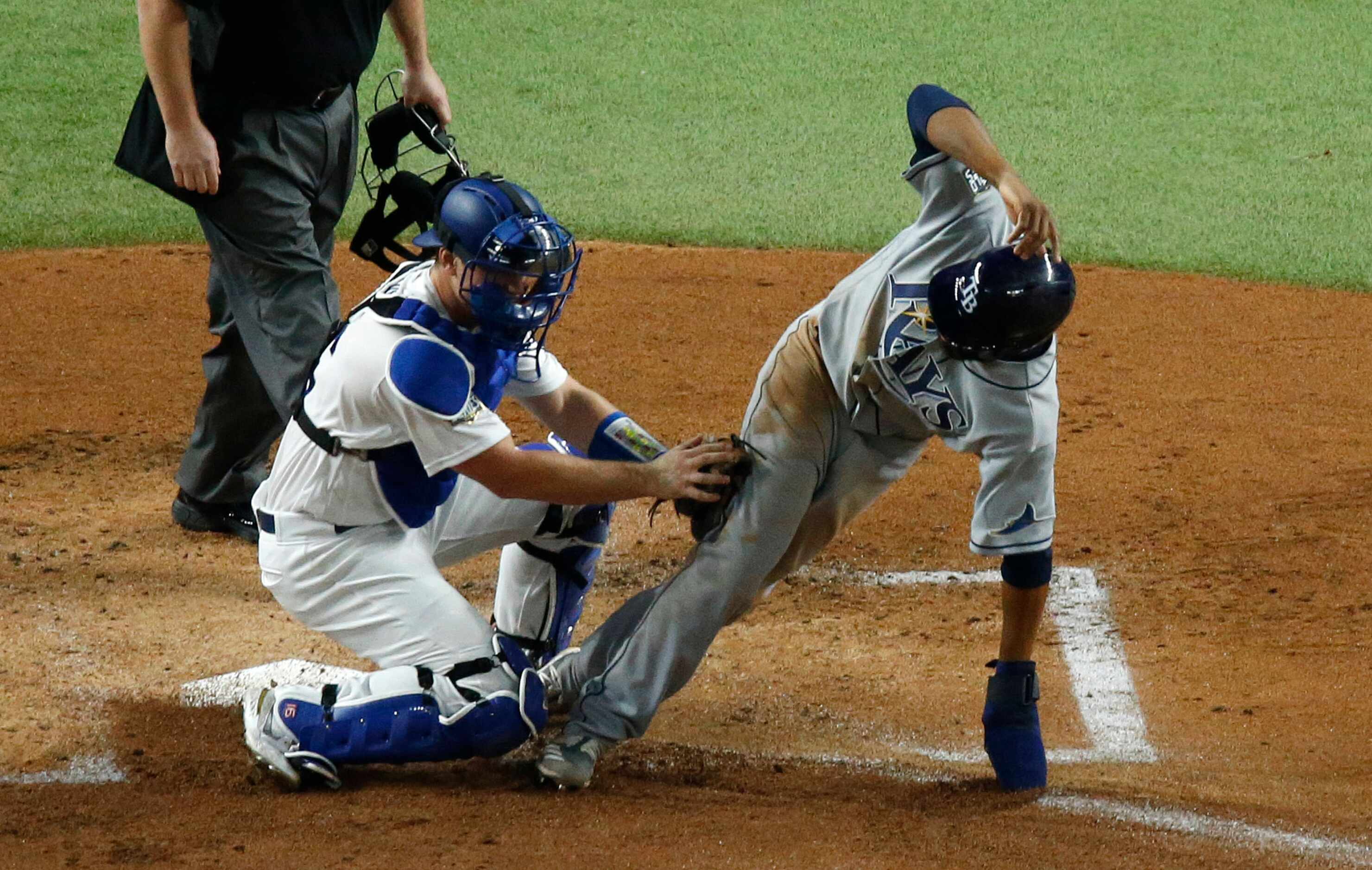 Tampa Bay Rays right fielder Manuel Margot (13) is tagged out at home by Los Angeles Dodgers...