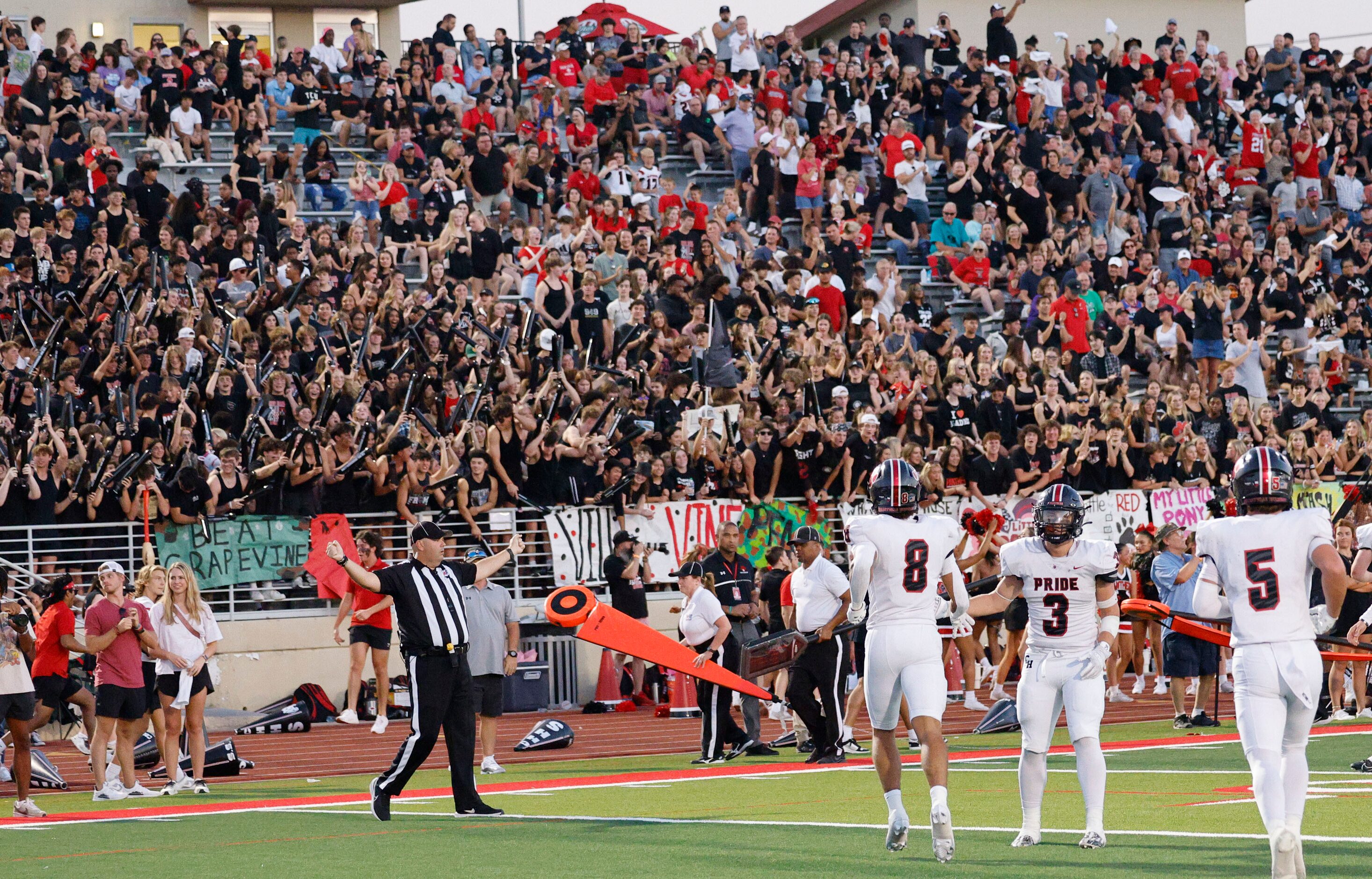 Colleyville Heritage's Braden Blueitt (8) gets a high-five from Colleyville Heritage's Ryan...