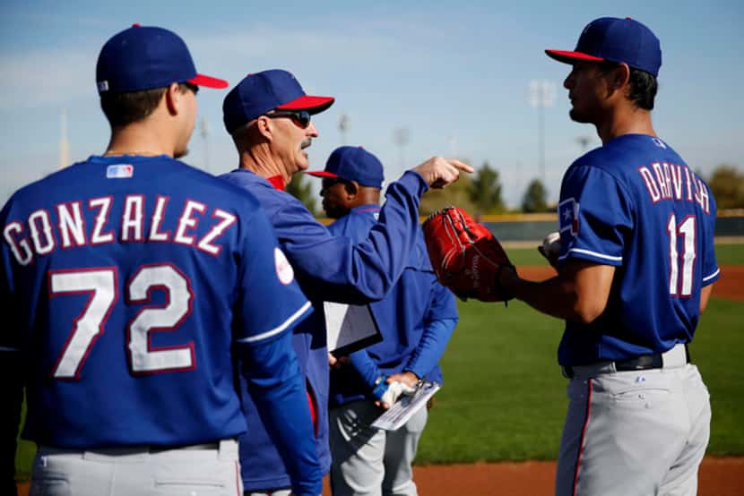  Texas Rangers pitching coach Mike Maddux speaks with pitcher Yu Darvish during a workout at...