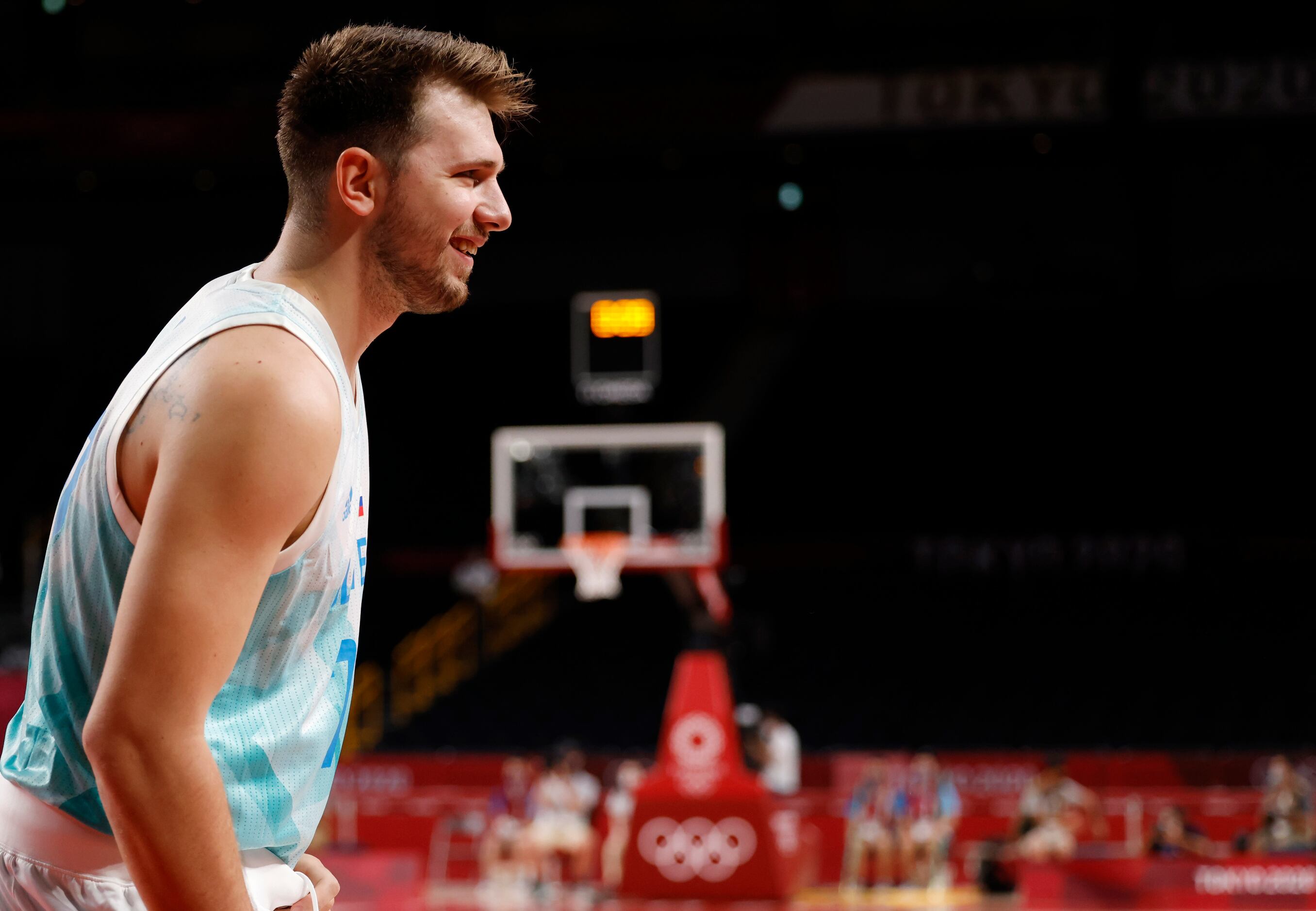 Slovenia’s Luka Doncic (77) smiles towards the bench in a basketball game against Japan...