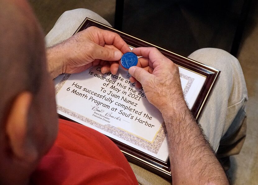 Juan Nunez holds his six-month sobriety chip at Soul’s Harbor.