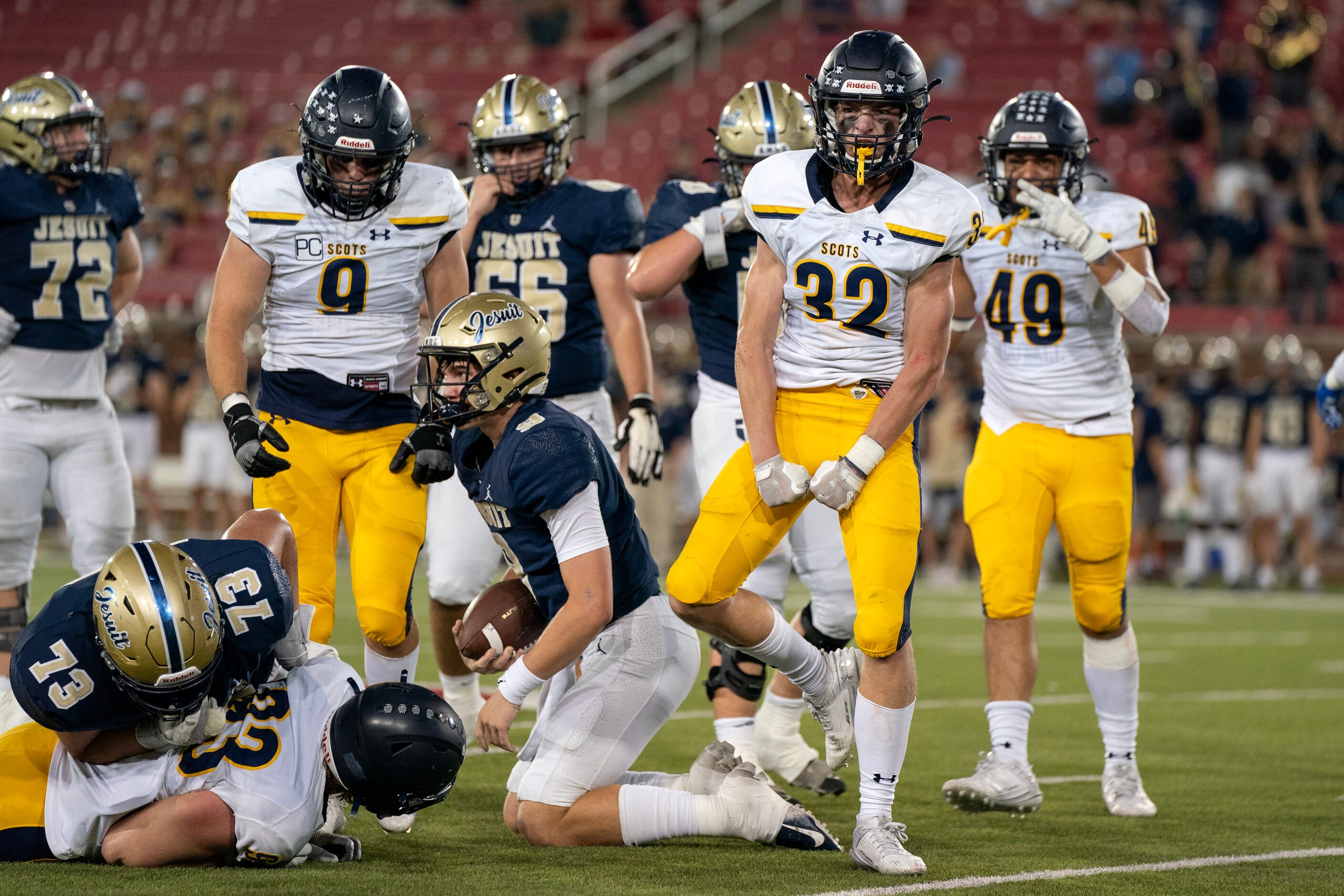 Highland Park senior linebacker Clark Cozby (32) celebrates after sacking Jesuit junior...