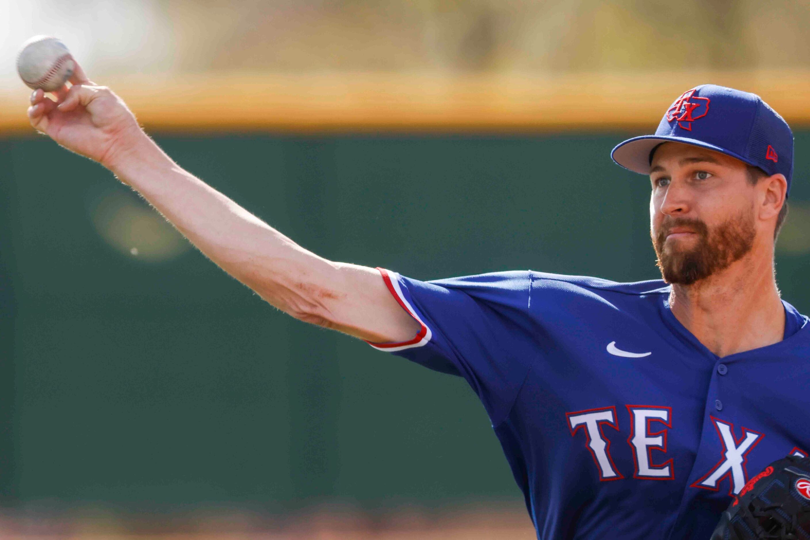 Texas Rangers pitcher Jacob deGrom throws a pitch during a spring training workout at the...