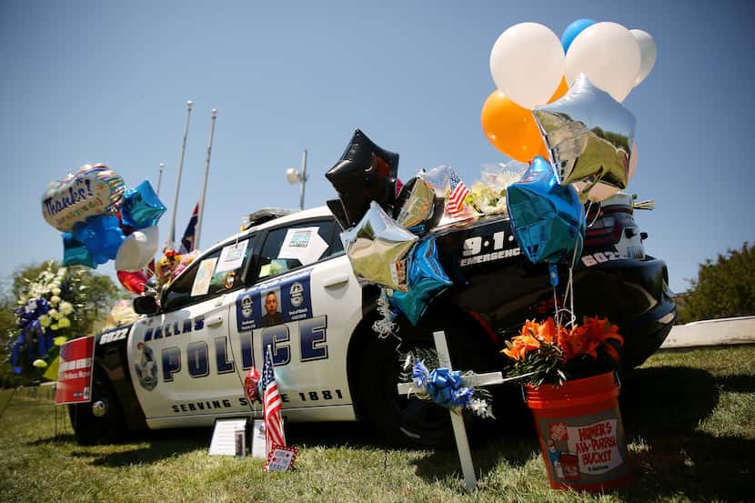Mementos sit on the car parked outside in honor of Dallas police officer Rogelio Santander...