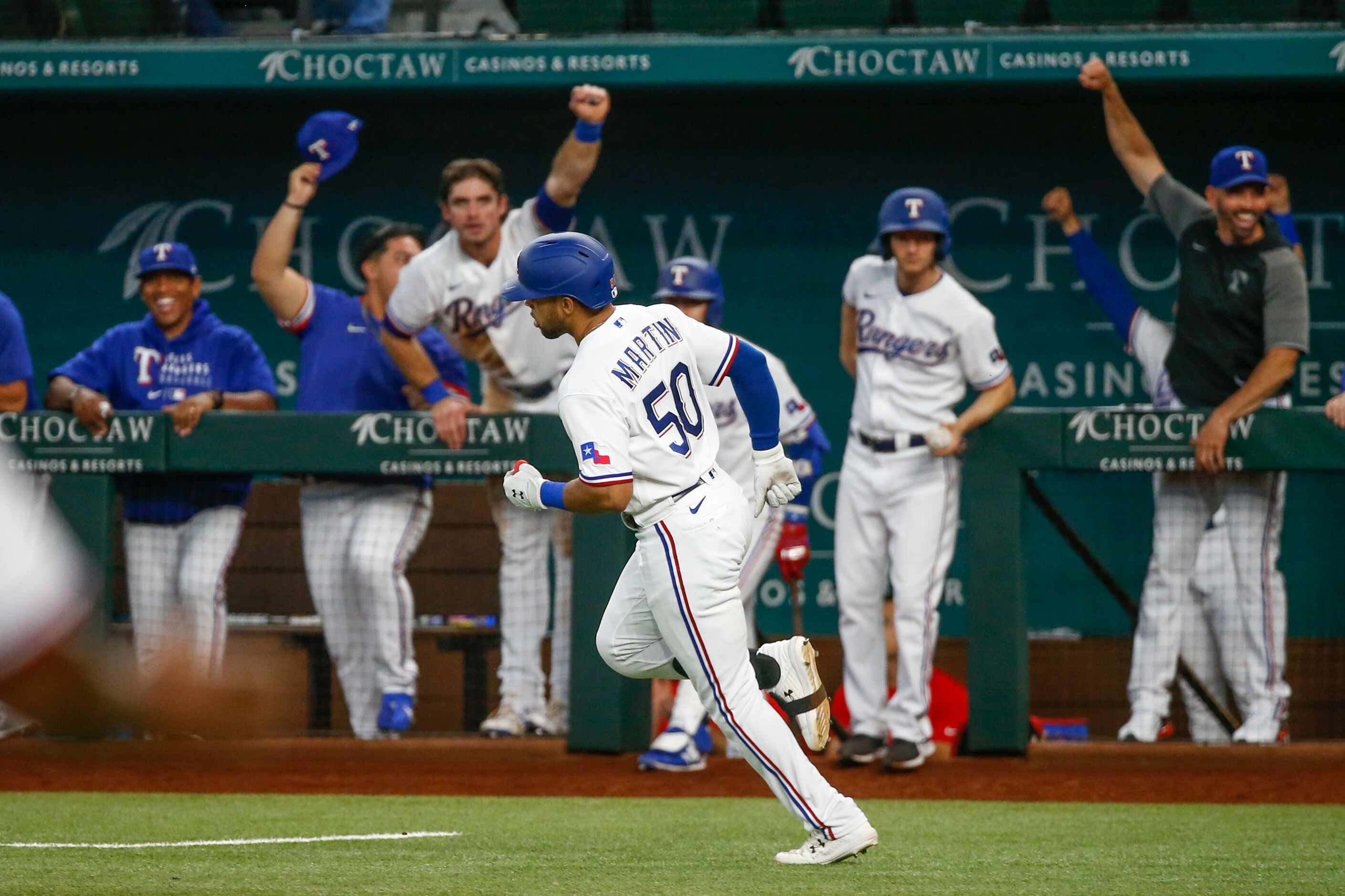 Texas Rangers left fielder Jason Martin (50) rounds the bases after hitting a three-run home...