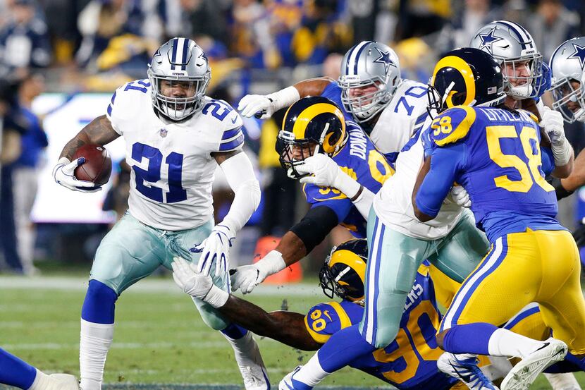 Dallas Cowboys running back Ezekiel Elliott (21) picks up the first down as the Cowboys went...