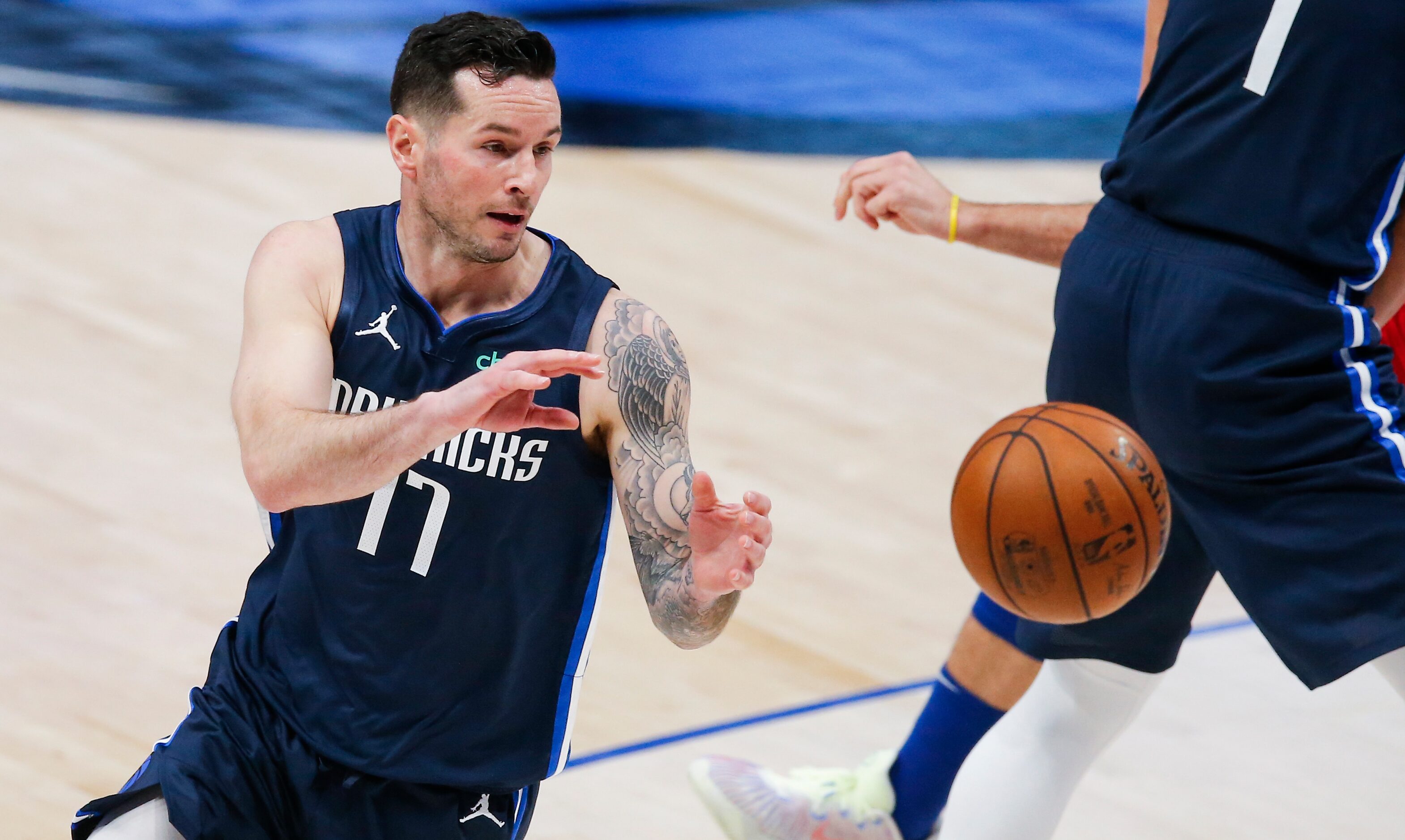 Dallas Mavericks guard JJ Redick (17) receives a pass during the first half of an NBA...