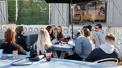 Customers drink and watch college basketball at Texas Tapyard on Saturday, March 18, 2023 in...