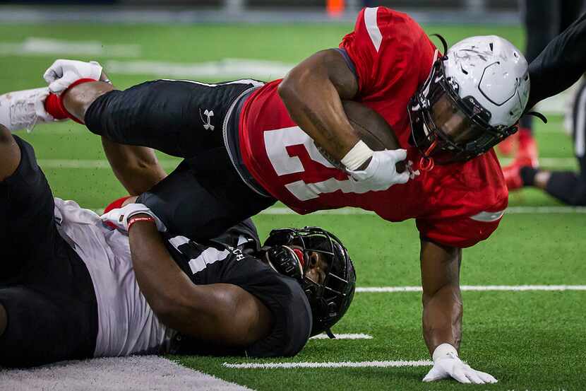 Texas Tech running back Da'Leon Ward (21) dives for extra yardage during the Red Raiders...