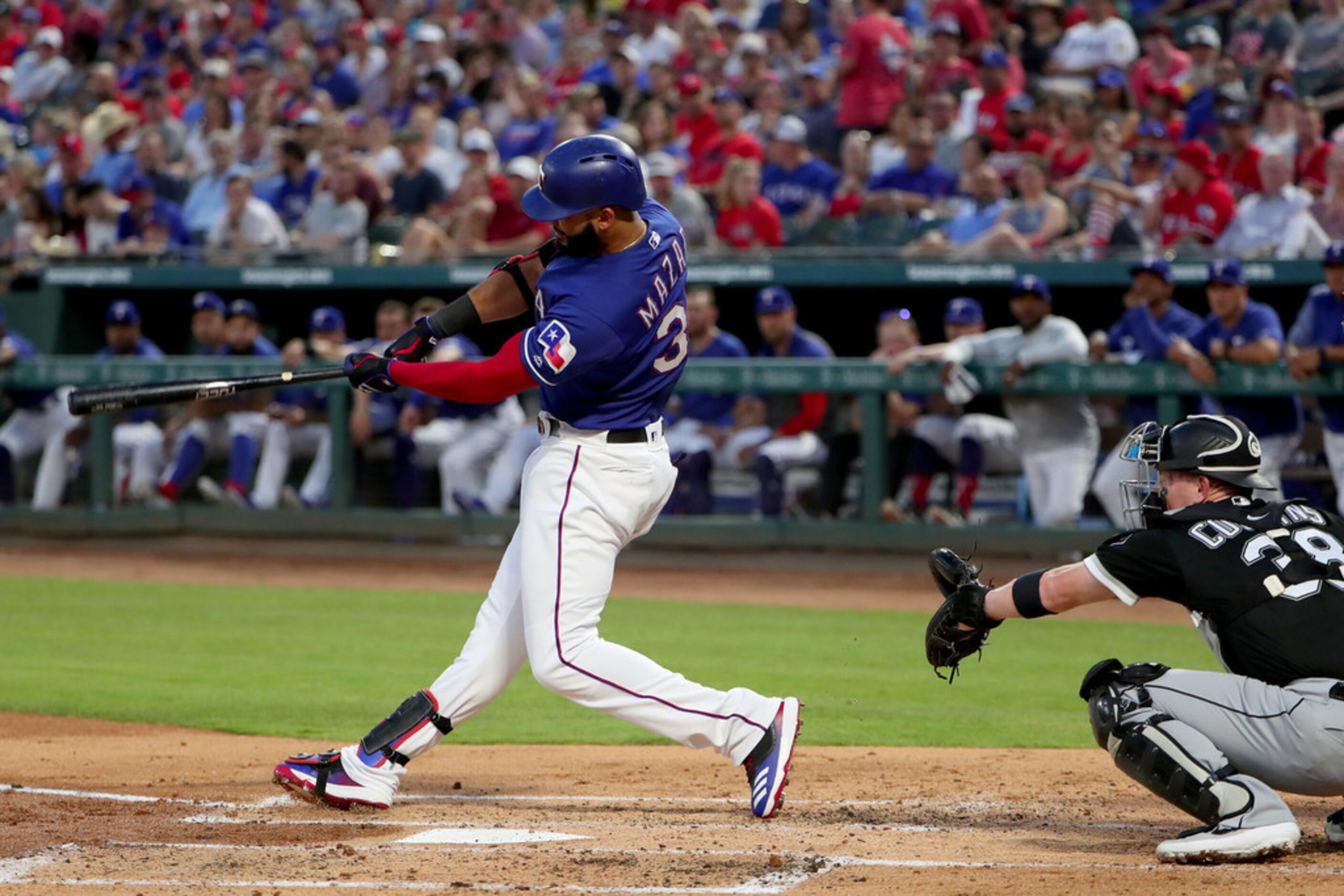 ARLINGTON, TEXAS - JUNE 22: Nomar Mazara #30 of the Texas Rangers hits a two-run home run...