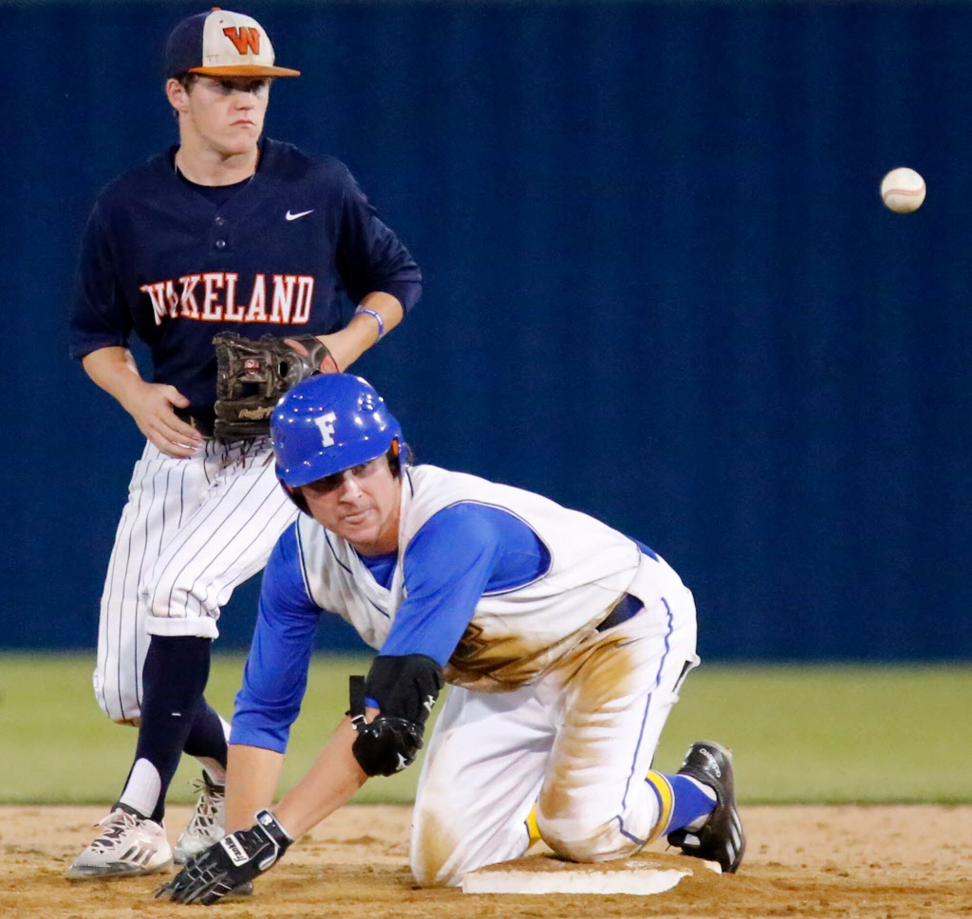 Frisco High School short stop Ryan Vilade (4) watches the baseball fall into play as he made...