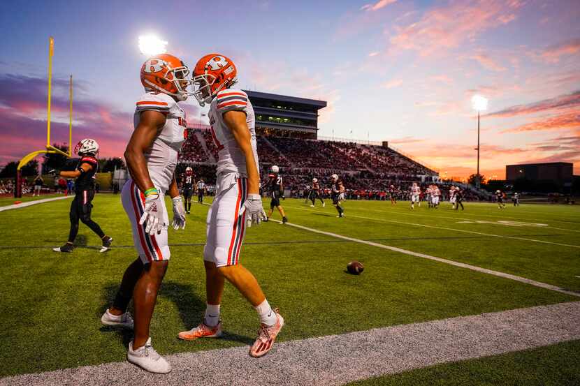 Rockwall wide receiver Caden Marshall (11) celebrates with Noble Johnson (3) after scoring...