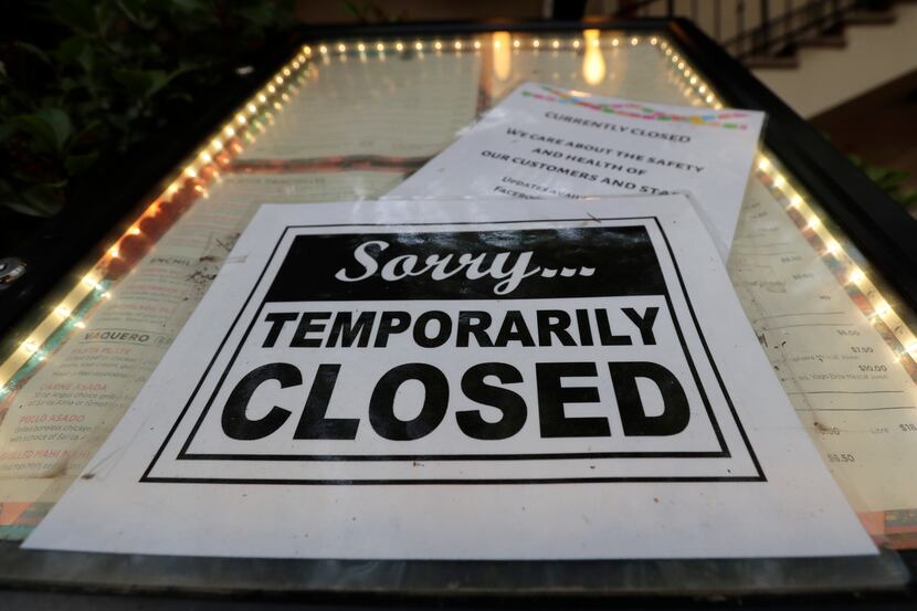 A closed sign is posted at a restaurant along the River Walk in San Antonio, Tuesday, April...