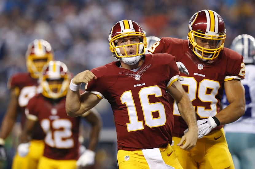 Washington Redskins quarterback Colt McCoy (16) celebrates his fourth quarter touchdown with...