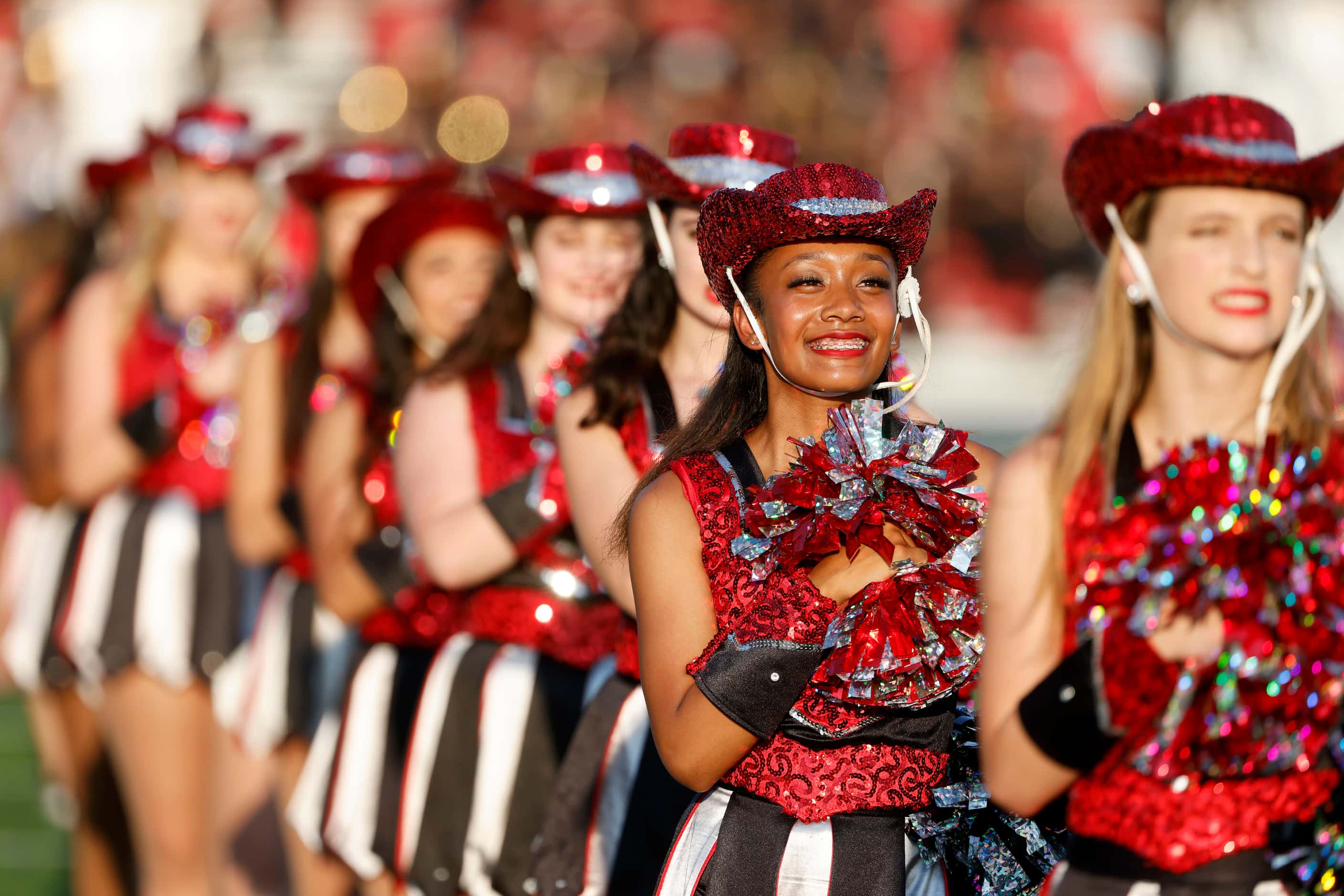 The Troy-Ann drill team of Euless Trinity performs prior to their their high school football...